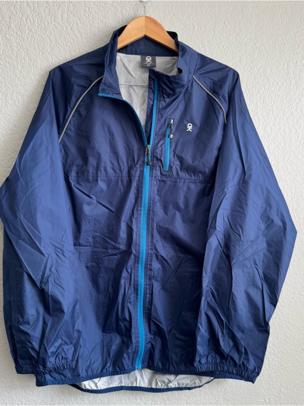 Little Donkey Andy Navy Packable Windbreaker with Bright Blue Zip